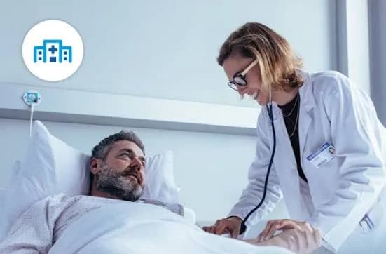 A doctor carefully examining a patient resting in a hospital bed