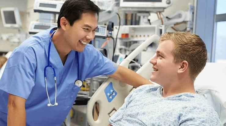 A care provider supporting a patient in a hospital setting