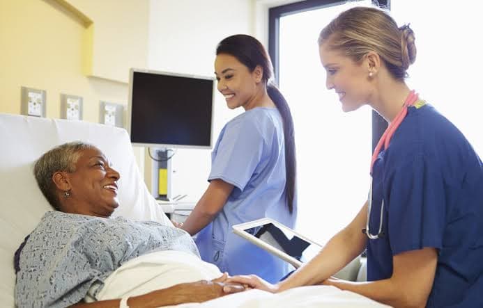A nurse checking in on a recovering patient