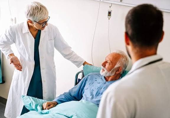 A doctor reviewing coverage options with a patient during a calm consultation